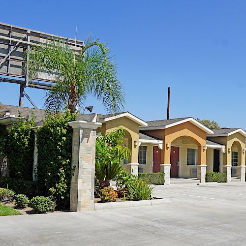 A row of pastel-colored motel units with a 