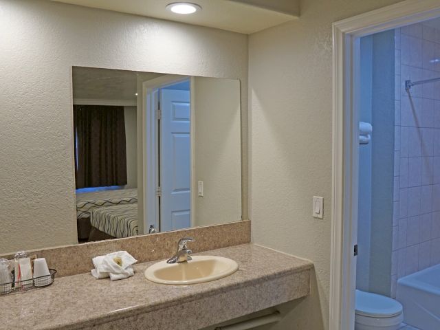 A bathroom with a sink, mirror, shower, toilet, and bathtub